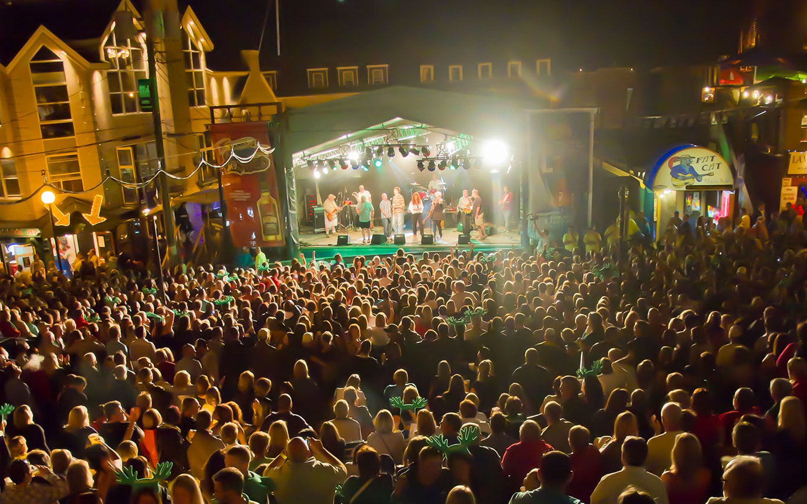 A packed George Street crowd in front of the festival main stage at night